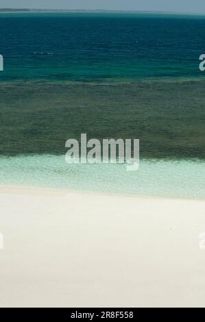 Cristal ocean waves breaking on white sand beach with turquoise emerald water - stock photo Stock Photo