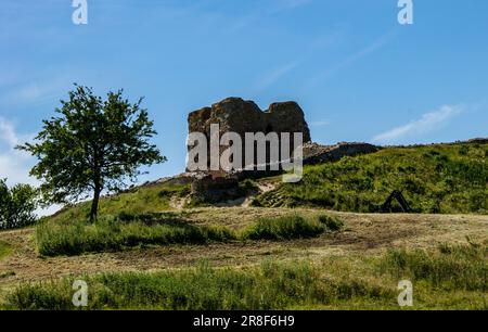 A picturesque view of Kalo Castle in Denmark, situated atop a lush, grassy hill Stock Photo