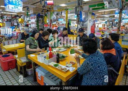 Busan, South Korea - May 28, 2023: People eating fish in the Jagalchi Market in Busan, South Korea. Stock Photo