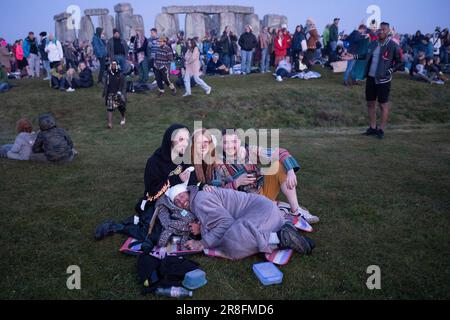 Spiritually-minded revellers celebrate the summer Solstice (mid-summer and longest day) at the ancient late-Neolithic stones of Stonehenge, on 21st June 2023, in Wiltshire, England. The summer solstice is the northern hemisphere's longest day and shortest night of the year, when the earth’s axis is tilted at its closest point from the sun and pagans say the ancient monument is a sacred place that links the Earth, Moon, Sun and the seasons. Stonehenge was built in three phases between 3,000 B.C. and 1,600 B.C. Stonehenge is owned by English Heritage who say 8,000 visitors were allowed into the Stock Photo