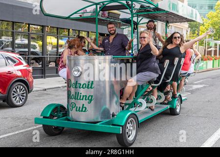 Detroit, Michigan, Happy partiers on a pedal pub in downtown Detroit. State and city laws allow groups to consume their own alcoholic drinks on pedal Stock Photo