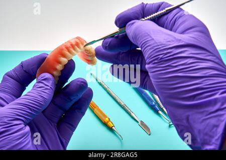 Dental Technician Making New Dental Prosthetics In Laboratory. Stock Photo