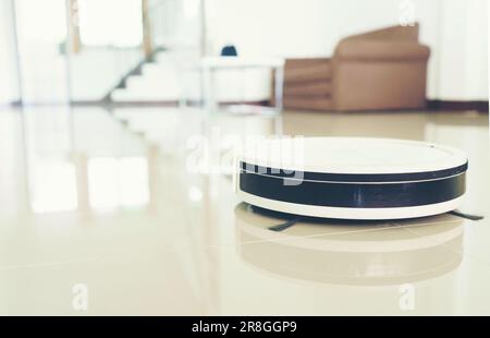 home vacuum cleaning robot cleaning the room Stock Photo