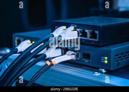 Several ethernet cables linked to a network router for establishing an internet connection Stock Photo