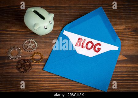 BLOG Concept. Blue letter envelope on dark wood background. Stock Photo