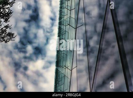 Clouds reflected in a glass sided building Stock Photo