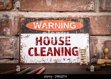 House Cleaning Concept. Warning sign with text on wooden texture table. Stock Photo
