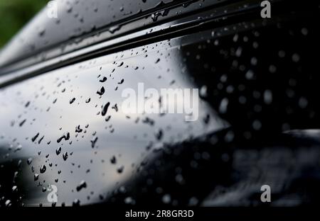 Selective focus of drops water on black metallic car body Stock Photo