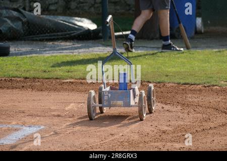 A field marking machine sits on the dirt at a baseball game. Stock Photo
