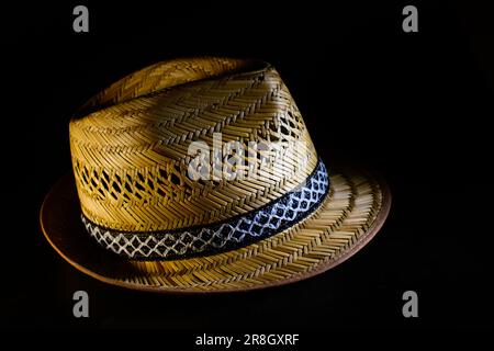 Real straw summer hat isolated on black background Stock Photo