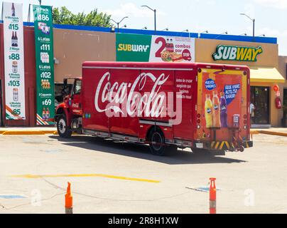 View from bus window big red Coca-Cola delivery truck lorry outside Subway store, Merida, Yucatan State, Mexico Stock Photo