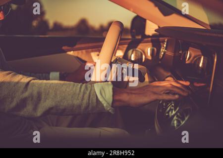 Closeup of Caucasian Driver Touching the Screen of Vehicle On-Board Computer. Modern Car Interior. Stock Photo