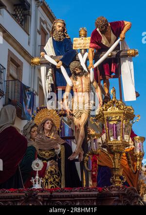 The throne with the figure of Jesus Christ on the cross next to the Virgin Mary, leaving the church during the celebration of the Holy Week in Baeza. Stock Photo