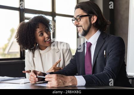 Cheerful multiracial team having fun during conference, office interior Stock Photo