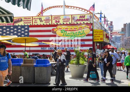 People relaxing at Famous Nathan's at Coney Island along Surf Avenue in Brooklyn, New York. Stock Photo