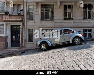 VW Beetle car in silver parked on a steep street in Istanbul, Turkey Stock Photo