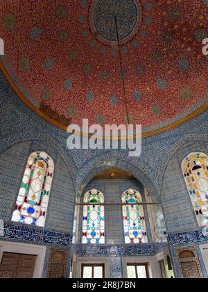 Elegant room inside the Topkapi Palace with blue and white tiles, stained glass windows and a red domed roof, Fatih district, Istanbul, Turkey Stock Photo