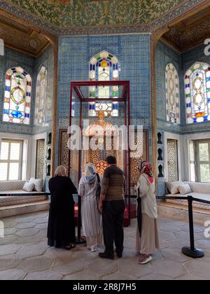 Tourists inside an Elegant room with stained glass windows inside the Topkapi Palace, Fatih district, Istanbul, Turkey Stock Photo