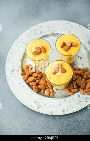 Authentic Indian cold drink made up of curd, milk malai called Lassi in saffron, kesar flavour, also called kesariya or keshariya or kesar lassi, serv Stock Photo