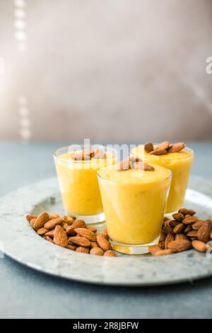 Authentic Indian cold drink made up of curd, milk malai called Lassi in saffron, kesar flavour, also called kesariya or keshariya or kesar lassi, serv Stock Photo