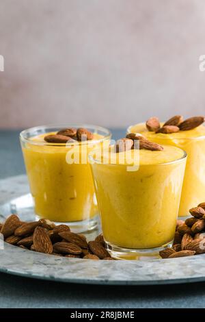 Authentic Indian cold drink made up of curd, milk malai called Lassi in saffron, kesar flavour, also called kesariya or keshariya or kesar lassi, serv Stock Photo