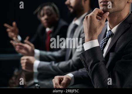 Close-up profile of a pensive manager, holding his hand on his c Stock Photo