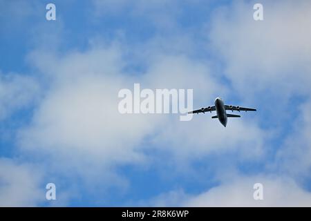A commuter passenger plane flying in a cloud filled sky Stock Photo