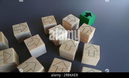 Green arrow leads other arrows. Leadership, in charge, setting trends and following concept Stock Photo
