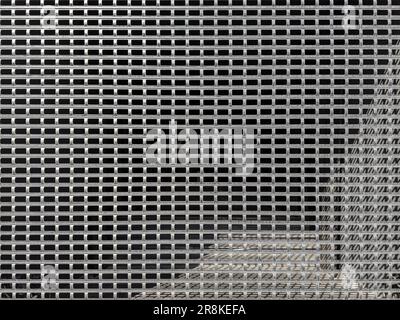 entrance with metal protective roller grille. meshed shutter background. geometric pattern. Stock Photo