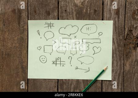 a piece of light paper with drawn speech bubbles Set of distorted circles rectangles and square empty trendy shapes, tictac-toe Stock Photo