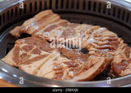 Korean pork ribs and beef marbled Korean BBQ style charcoal grill Stock Photo