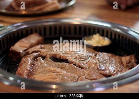 Korean pork ribs and beef marbled Korean BBQ style charcoal grill Stock Photo
