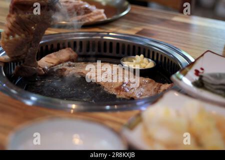 Korean pork ribs and beef marbled Korean BBQ style charcoal grill Stock Photo
