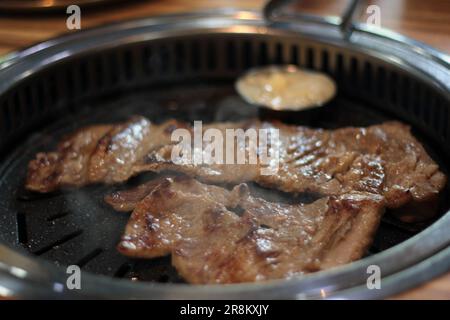Korean pork ribs and beef marbled Korean BBQ style charcoal grill Stock Photo