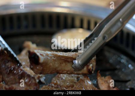 Korean pork ribs and beef marbled Korean BBQ style charcoal grill Stock Photo