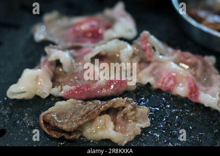 Korean pork ribs and beef marbled Korean BBQ style charcoal grill Stock Photo