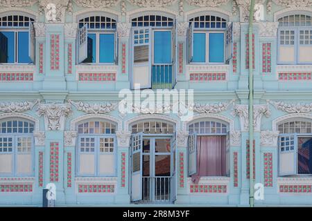 Facade of a row of light blue Straits Chinese Peranakan residential houses in the Jalan Besar Conservation Area, Singapore Stock Photo