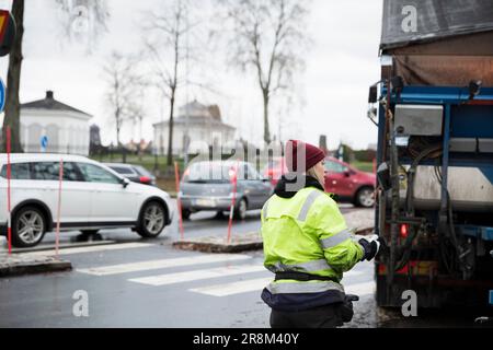 Young female construction worker operating machinery Stock Photo
