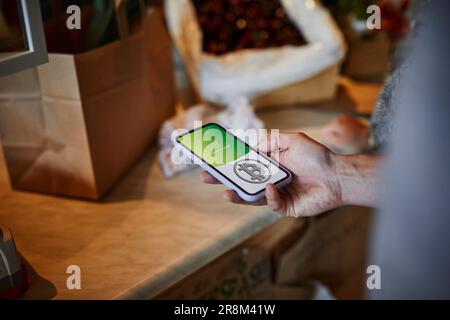 Person paying with bitcoin crypto currency for groceries Stock Photo