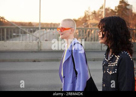 Smiling young women walking together Stock Photo