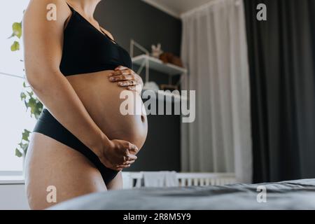 Close-up of pregnant woman touching belly Stock Photo