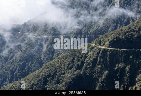 Driving the famous death road, the 'Camino de la Muerte', in the Bolivian Andes near La Paz - traveling and exploring the Yungas Stock Photo