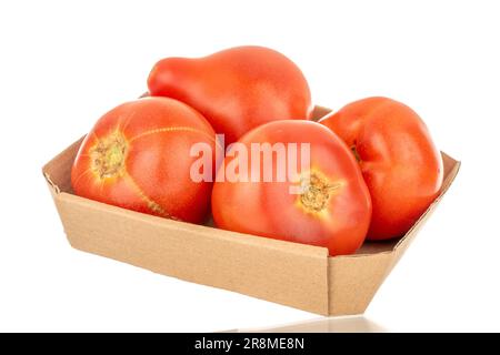 Several juicy red tomatoes on a paper tray, macro, isolated on white background. Stock Photo