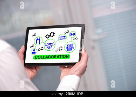 Collaboration concept shown on a tablet held by a man Stock Photo