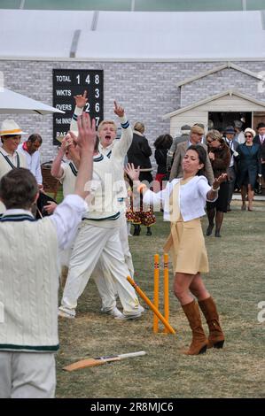 Amanda Stretton, female motorsport and motor industry TV presenter, playing cricket for the cameras at the Goodwood Revival 2012, UK. Acting Stock Photo