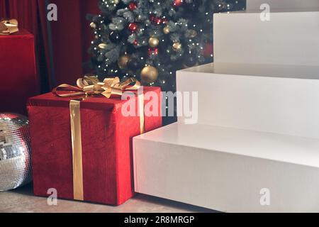 Minimalistic podium scene in the form of a ladder on the background of a Christmas tree with balloons. Rectangular white podium for the presentation of goods with space for copying. High quality photo Stock Photo