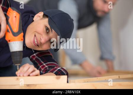 female worker using a cordless drill Stock Photo