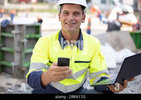 builder manager using laptop and mobile phone Stock Photo