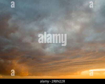 Orange dramatic cloudy sunset sky background overlay. Ideal for sky replacement, screen saver or any other application Stock Photo