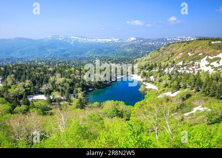 Kumanuma in Hachimantai-daira and a mountain range with lingering snow Stock Photo